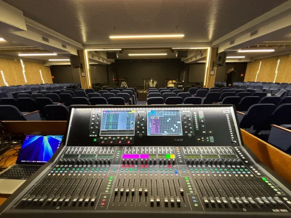 A digital mixing console set up in an empty auditorium before the show
