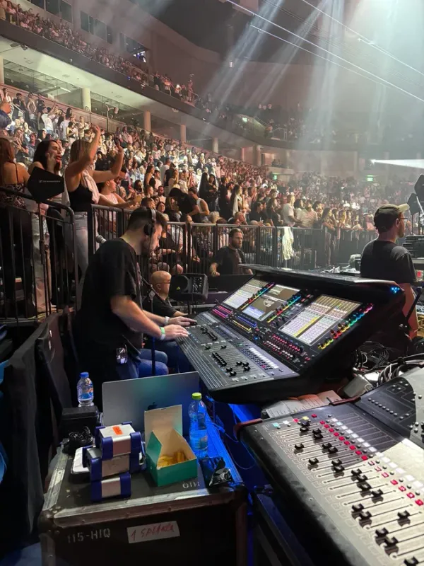 Mixing position during a show, with a full audience behind the barrier