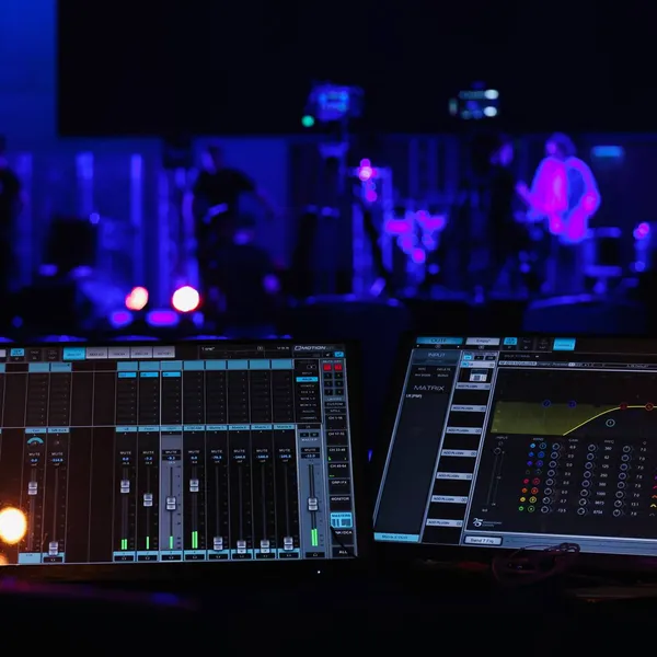 Console surface in the foreground, a stage lit in purple behind it